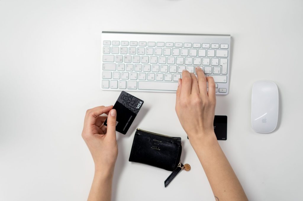 Someone holding a credit card while buying online