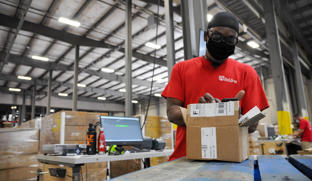 Warehouse working inspecting a return